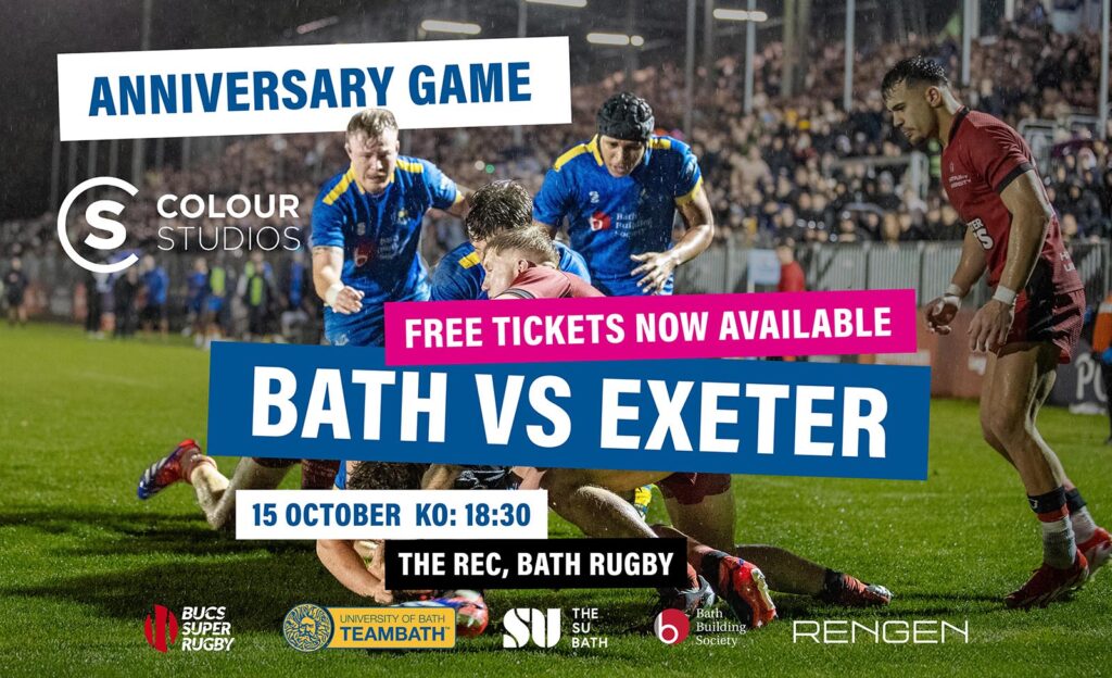 Two University of Bath rugby players, wearing blue, run to support a maul. Behind them is a packed stand of spectators at The Rec, sitting underneath floodlights. Over the image is text saying: "Anniversary Game. Free tickets now available. Bath vs Exeter. 15 October. KO 18:30. The Rec, Bath Rugby."