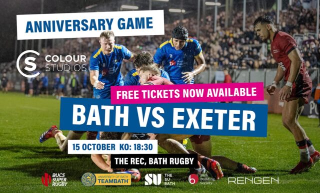 Two University of Bath rugby players, wearing blue, run to support a maul. Behind them is a packed stand of spectators at The Rec, sitting underneath floodlights. Over the image is text saying: "Anniversary Game. Free tickets now available. Bath vs Exeter. 15 October. KO 18:30. The Rec, Bath Rugby."
