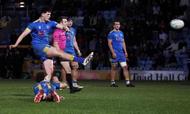 Isaac Mears, lying face down, holds the ball as James Beverley kicks the winning penalty for the University of Bath men's 1st XV against Exeter at Sandy Park