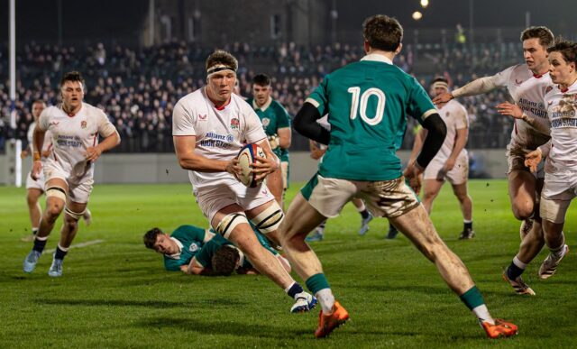England's Connor Treacey carries the ball as he is closed down by an Ireland opponent.