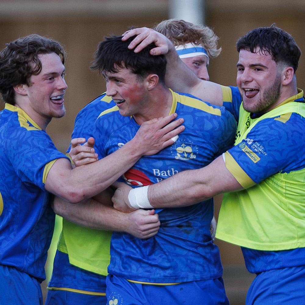 Sam Winters is congratulated by his team-mates after scoring a try for the University of Bath men's 1st XV
